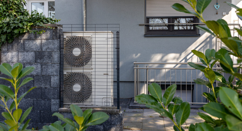 Air source heat pumps installed on the garden front of a modern