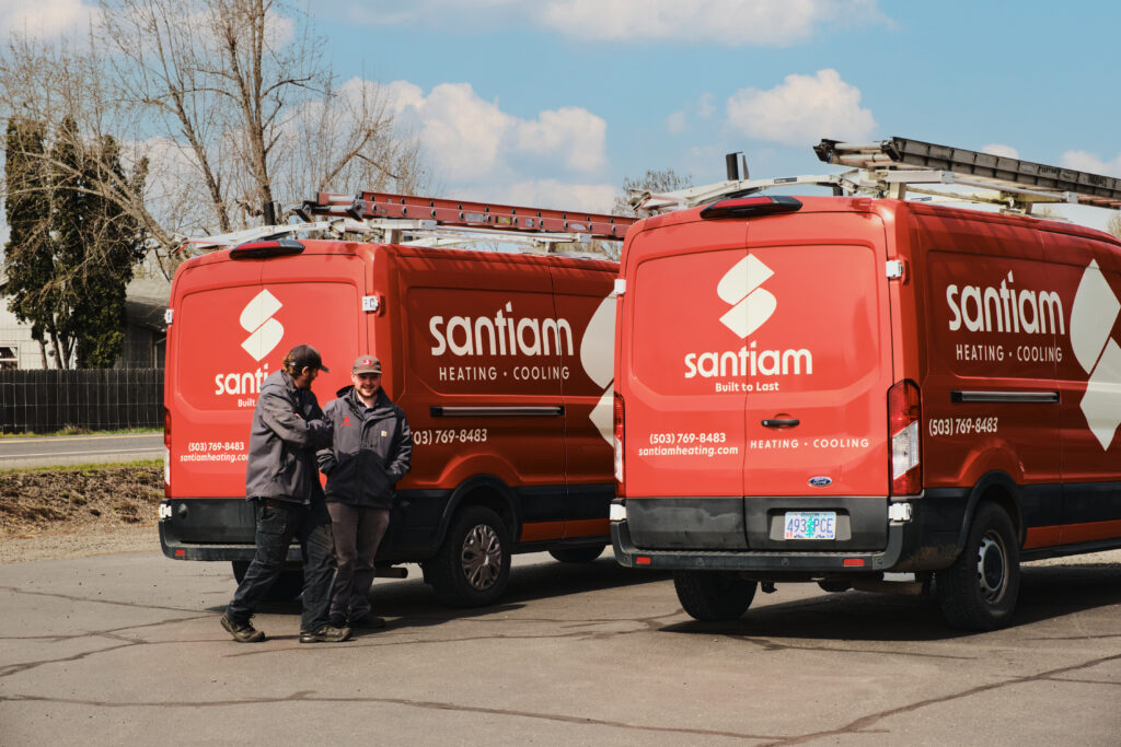 Crew members standing beside service trucks